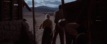 Movie still from “Unforgiven” (1992), directed by Clint Eastwood – A man and a woman standing in a field; Wide shot, Over the shoulder angle