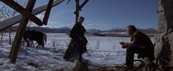 Movie still from “Unforgiven” (1992), directed by Clint Eastwood – A woman standing in the middle of a snowy field; Wide shot, Over the shoulder angle