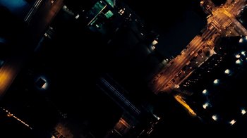 Movie still from “Untrapped: The Story of Lil Baby” (2022), directed by Karam Gill – An aerial view of a city at night with lights; Extreme Wide shot, Overhead angle