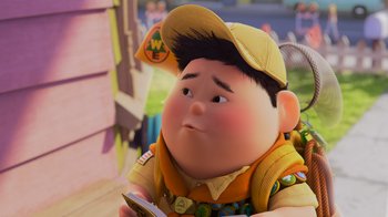 Movie still from “Up” (2009), directed by Bob Peterson – A character from up holding a book; Close Up shot, High angle