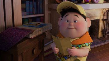 Movie still from “Up” (2009), directed by Bob Peterson – An animated character holding a book in his hands; Medium shot, High angle