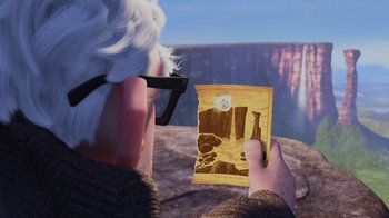 Movie still from “Up” (2009), directed by Bob Peterson – An old man holding a picture of a waterfall; Medium shot, Over the shoulder angle