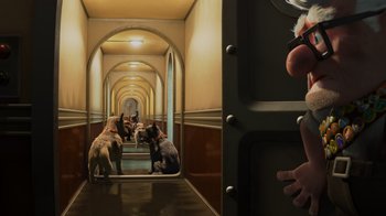 Movie still from “Up” (2009), directed by Bob Peterson – Two dogs in a hallway with a person looking at them; Wide shot, High angle
