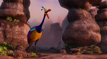 Movie still from “Up” (2009), directed by Bob Peterson – A colorful bird standing in the middle of a rocky area; Wide shot, High angle