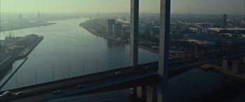 Movie still from “Upgrade” (2018), directed by Leigh Whannell – An aerial view of a bridge over a body of water; Extreme Wide shot, High angle