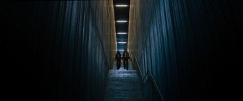Movie still from “Upgrade” (2018), directed by Leigh Whannell – Two people walking down a set of stairs; Extreme Wide shot, High angle
