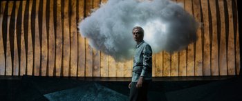 Movie still from “Upgrade” (2018), directed by Leigh Whannell – A man standing in front of a cloud of smoke; Medium shot, Low angle