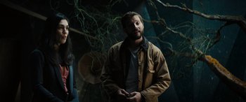 Movie still from “Upgrade” (2018), directed by Leigh Whannell – A man standing in front of a tree with his hands in his pockets; Medium shot, Low angle