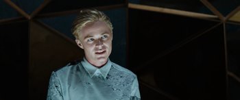 Movie still from “Upgrade” (2018), directed by Leigh Whannell – A man with blonde hair wearing a white shirt; Close Up shot, Low angle