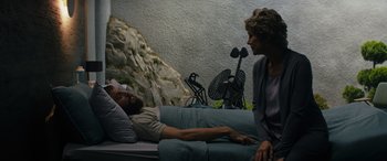 Movie still from “Upgrade” (2018), directed by Leigh Whannell – A man laying on a bed next to a woman; Wide shot, High angle