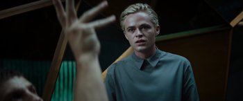 Movie still from “Upgrade” (2018), directed by Leigh Whannell – A man in a green shirt is looking at the camera; Close Up shot, Low angle