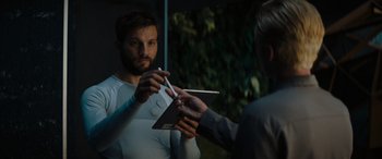 Movie still from “Upgrade” (2018), directed by Leigh Whannell – A man holding a pair of chopsticks in front of another man; Close Up shot, Over the shoulder angle