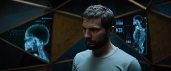 Movie still from “Upgrade” (2018), directed by Leigh Whannell – A person with a beard looking to his left; Close Up shot, Low angle