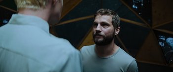 Movie still from “Upgrade” (2018), directed by Leigh Whannell – A man with a goatee is looking into the mirror; Close Up shot, Over the shoulder angle