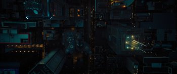 Movie still from “Upgrade” (2018), directed by Leigh Whannell – An aerial view of a city at night with lights; Extreme Wide shot, Overhead angle