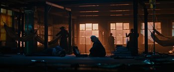 Movie still from “Upgrade” (2018), directed by Leigh Whannell – A person sitting on the floor with a laptop; Extreme Wide shot, Low angle