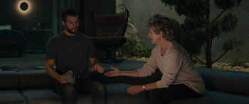 Movie still from “Upgrade” (2018), directed by Leigh Whannell – A man and a woman are sitting on a bench talking; Medium shot, High angle