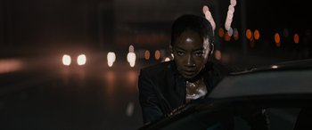 Movie still from “Upgrade” (2018), directed by Leigh Whannell – A woman in a leather jacket looking at the camera; Close Up shot, Low angle