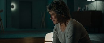 Movie still from “Upgrade” (2018), directed by Leigh Whannell – An older woman sitting in front of a window; Close Up shot, Over the shoulder angle