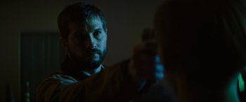Movie still from “Upgrade” (2018), directed by Leigh Whannell – A man taking a picture of another man with a cell phone; Close Up shot, Over the shoulder angle