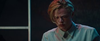 Movie still from “Upgrade” (2018), directed by Leigh Whannell – A man with blonde hair and a white dress shirt; Close Up shot, Low angle