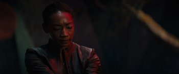 Movie still from “Upgrade” (2018), directed by Leigh Whannell – A woman in a leather jacket with blood on her face; Close Up shot, Over the shoulder angle