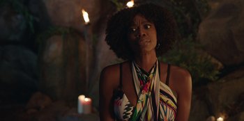 Movie still from “Vacation Friends” (2021), directed by Clay Tarver – A black woman with a surprised look on her face; Close Up shot, Over the shoulder angle