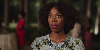 Movie still from “Vacation Friends” (2021), directed by Clay Tarver – A person wearing a floral shirt; Close Up shot, Over the shoulder angle