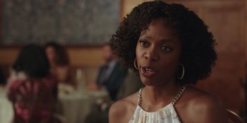 Movie still from “Vacation Friends” (2021), directed by Clay Tarver – A person wearing a dress; Close Up shot, Over the shoulder angle