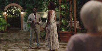 Movie still from “Vacation Friends” (2021), directed by Clay Tarver – A man and a woman standing next to each other in front of a gazebo; Wide shot, Over the shoulder angle