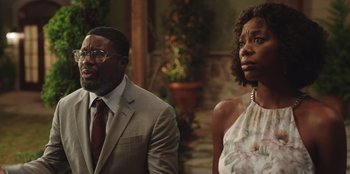 Movie still from “Vacation Friends” (2021), directed by Clay Tarver – A man and a woman standing next to each other; Medium shot, Over the shoulder angle