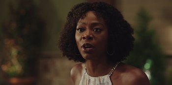 Movie still from “Vacation Friends” (2021), directed by Clay Tarver – A person wearing a white shirt; Close Up shot, Over the shoulder angle