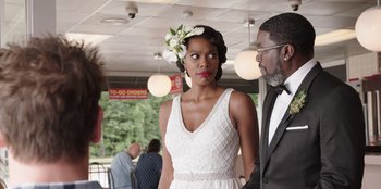 Movie still from “Vacation Friends” (2021), directed by Clay Tarver – A man and a woman standing next to each other; Medium shot, Over the shoulder angle