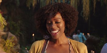 Movie still from “Vacation Friends” (2021), directed by Clay Tarver – A person smiling with her eyes closed; Close Up shot, Over the shoulder angle