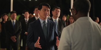 Movie still from “Vacation Friends 2” (2023), directed by Clay Tarver – A group of men in suits and ties standing next to each other; Medium shot, Over the shoulder angle