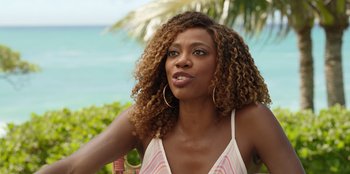 Movie still from “Vacation Friends 2” (2023), directed by Clay Tarver – A beautiful woman sitting in front of the ocean; Close Up shot, Over the shoulder angle