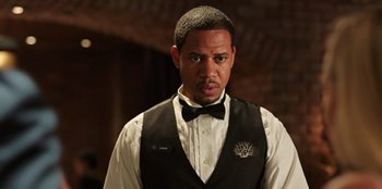 Movie still from “Vacation Friends 2” (2023), directed by Clay Tarver – A man wearing a vest and a bow tie; Close Up shot, Over the shoulder angle