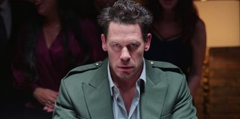 Movie still from “Vacation Friends 2” (2023), directed by Clay Tarver – A person wearing a jacket; Close Up shot, Over the shoulder angle