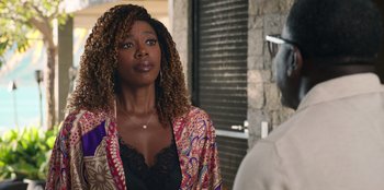 Movie still from “Vacation Friends 2” (2023), directed by Clay Tarver – A woman in a black top is looking at a man; Close Up shot, Over the shoulder angle