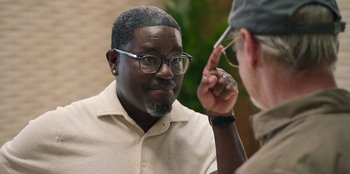 Movie still from “Vacation Friends 2” (2023), directed by Clay Tarver – A man with glasses is looking at another man with glasses; Close Up shot, Over the shoulder angle