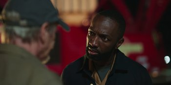 Movie still from “Vacation Friends 2” (2023), directed by Clay Tarver – A man with a beard is talking to another man; Close Up shot, Over the shoulder angle