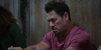 Movie still from “Vacation Friends 2” (2023), directed by Clay Tarver – A person wearing a pink t - shirt; Close Up shot, High angle