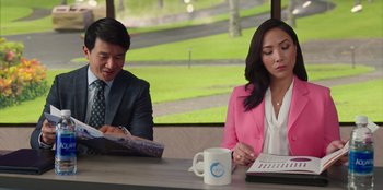Movie still from “Vacation Friends 2” (2023), directed by Clay Tarver – A man and a woman sitting at a table; Medium shot, Over the shoulder angle