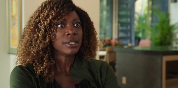 Movie still from “Vacation Friends 2” (2023), directed by Clay Tarver – A person with curly hair; Close Up shot, Over the shoulder angle