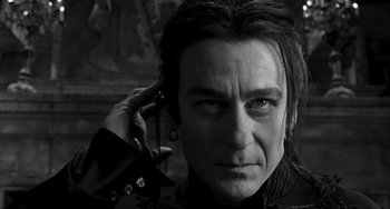 Movie still from “Van Helsing” (2004), directed by Stephen Sommers – A person holding a cell phone to his ear; Close Up shot, Low angle