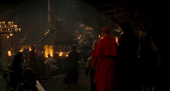 Movie still from “Van Helsing” (2004), directed by Stephen Sommers – A group of people standing around a fire pit; Wide shot, High angle