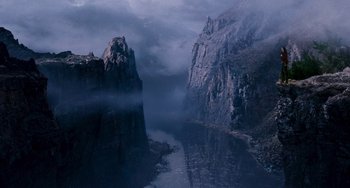 Movie still from “Van Helsing” (2004), directed by Stephen Sommers – A view of a body of water with a mountain in the background; Extreme Wide shot, High angle