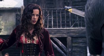 Movie still from “Van Helsing” (2004), directed by Stephen Sommers – A woman with long curly hair wearing a corset; Medium shot, Low angle