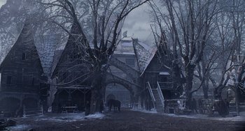 Movie still from “Van Helsing” (2004), directed by Stephen Sommers – A horse standing in the middle of a road near some trees; Extreme Wide shot, Low angle