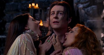 Movie still from “Van Helsing” (2004), directed by Stephen Sommers – A group of people that are around a man; Medium shot, Low angle